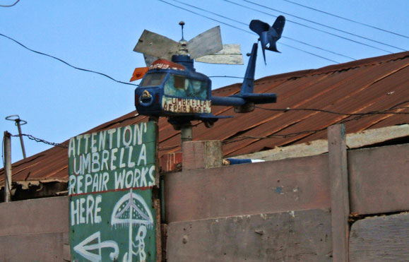 helicopter whirligig atop an umbrella-repait shop in Nima, Accra, Ghana.