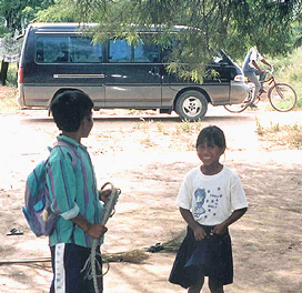 children, a van and a man on a bicycle